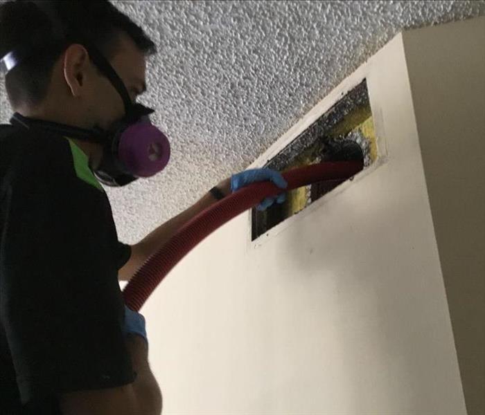 SERVPRO technician cleaning an air duct in Boca Raton, FL.