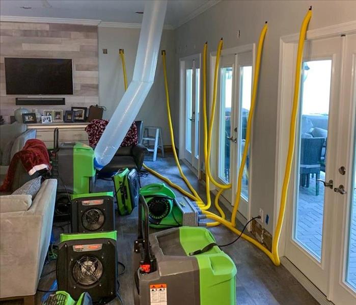 SERVPRO equipment set up to dry water behind the walls of a Boca Raton home