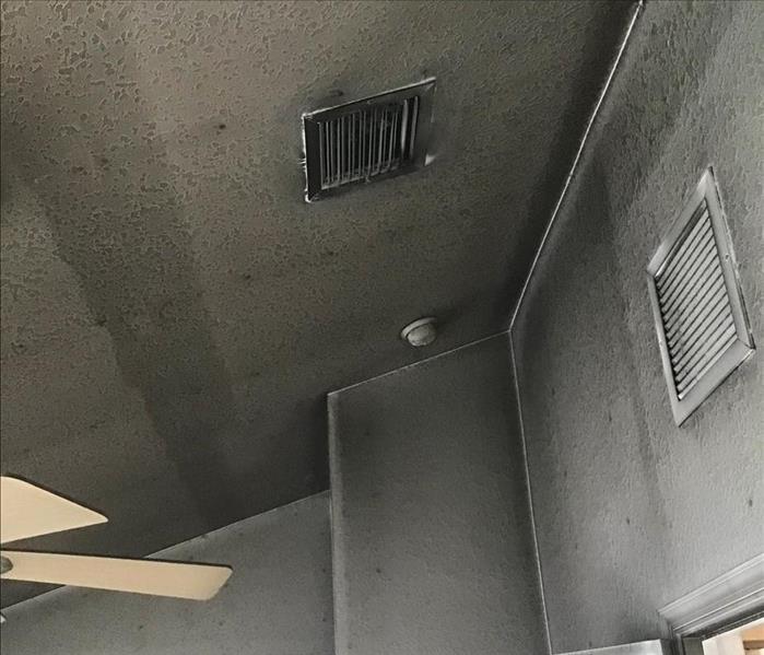 Soot covering wall and ceiling.