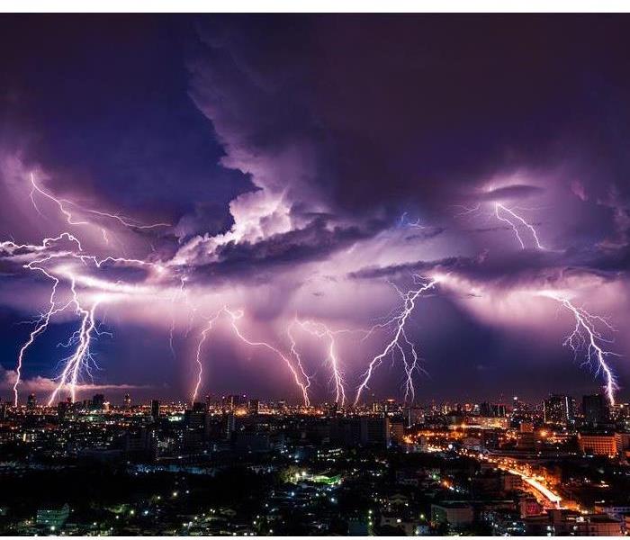 Lightning striking over a city at night